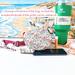 A red, turquoise and yellow floral print water bottle bag is displayed with a 40 oz Stanley Quencher tumbler, cell phone, money & chap stick